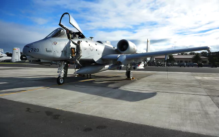 A Fairchild Republic A-10 Thunderbolt II on the tarmac, showcasing its iconic design and ready for action. This HD wallpaper captures the essence of military aviation.