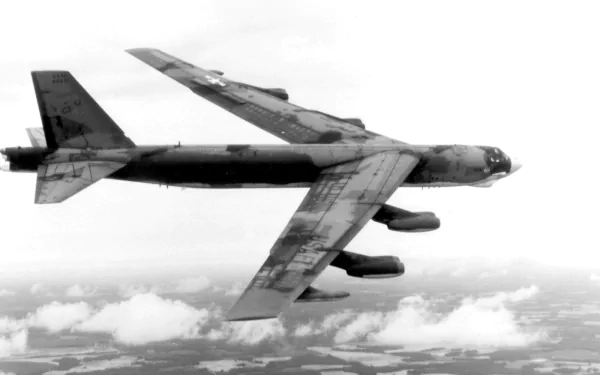 A Boeing B-52 Stratofortress flying over clouds, showcasing its military design. This HD image serves as a striking desktop wallpaper and background.