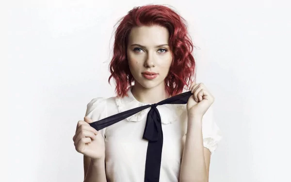 HD desktop wallpaper features an American actress with red hair and blue eyes, holding a black ribbon against a white background.