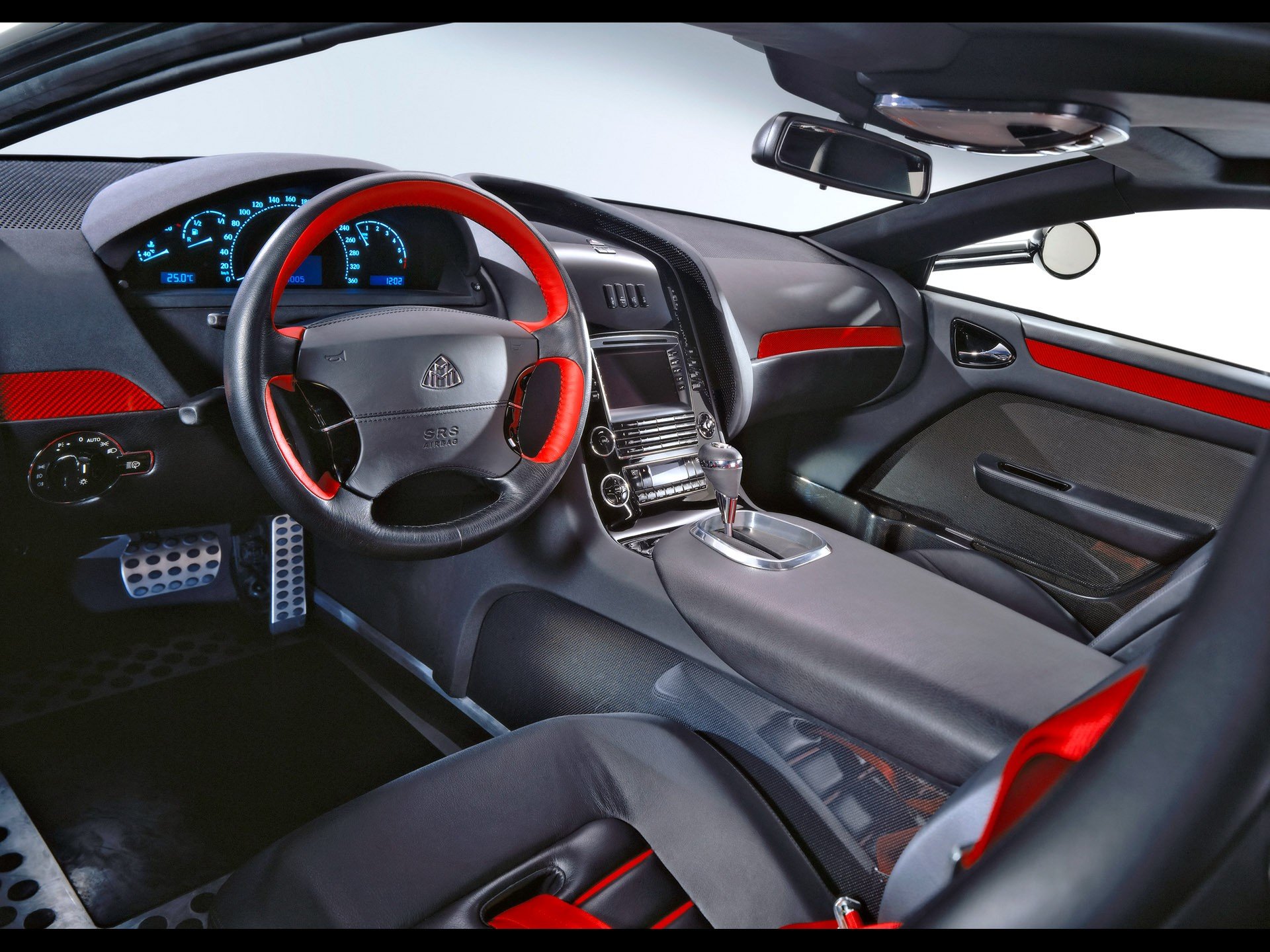 HD PC desktop wallpaper showcasing the sleek, modern interior of a Maybach vehicle with black and red accents and advanced dashboard displays.