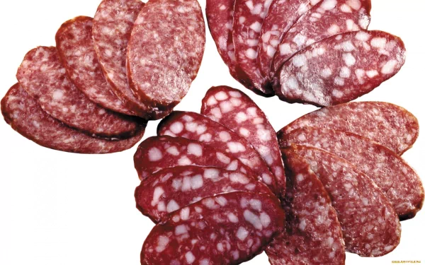 HD desktop wallpaper featuring close-up slices of salami arranged on a white background, highlighting the texture and marbling of the cured meat.