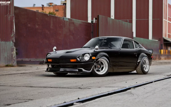 A sleek black Datsun vehicle parked on an urban street, showcased as an HD PC desktop wallpaper and background.