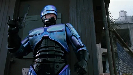 RoboCop from the 1987 movie stands in a dark urban setting, featured in an HD PC desktop wallpaper and background.