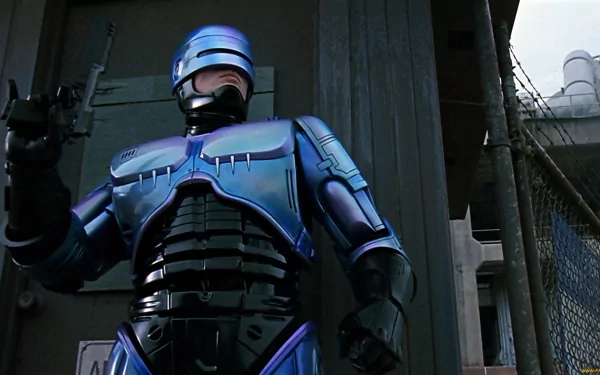 RoboCop from the 1987 movie stands in a dark urban setting, featured in an HD PC desktop wallpaper and background.