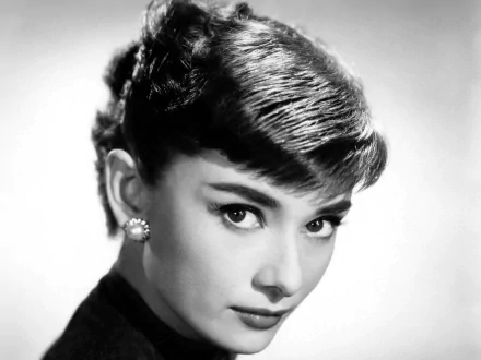 HD PC desktop wallpaper: black-and-white close-up portrait of a poised young woman with short bangs and pearl earrings, radiating classic 1950s Hollywood glamour.