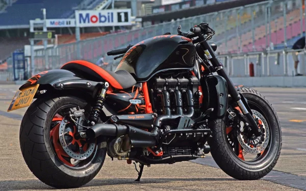 HD PC desktop wallpaper featuring a Triumph Rocket III motorcycle parked on a racetrack with Mobil 1 signage in the background.