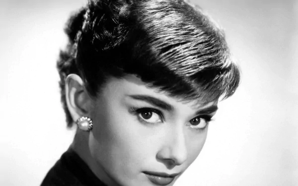 HD PC desktop wallpaper: black-and-white close-up portrait of a poised young woman with short bangs and pearl earrings, radiating classic 1950s Hollywood glamour.