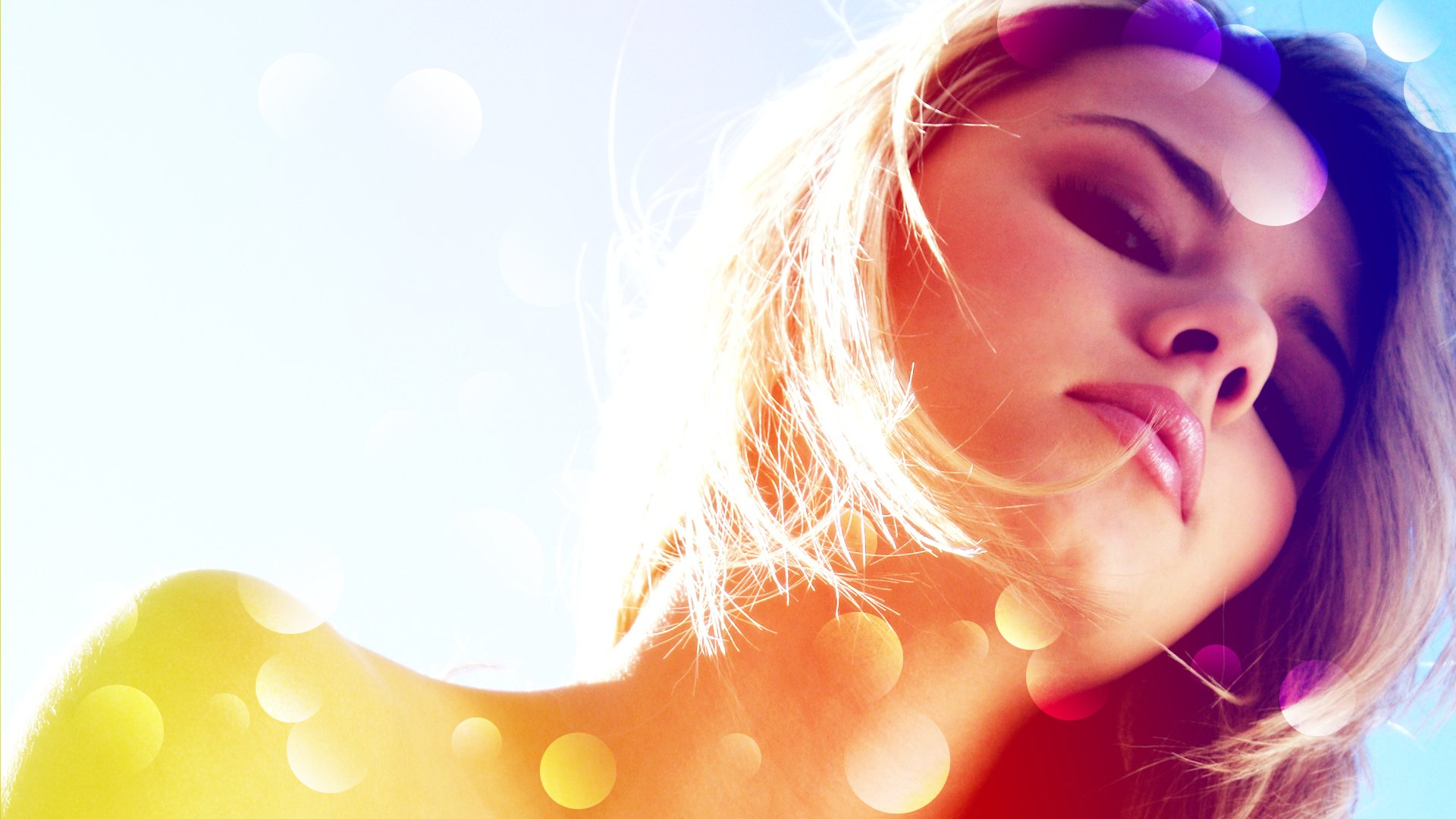 HD desktop wallpaper featuring a model with sunlit hair against a soft pastel background, subtly accented with bokeh light effects.