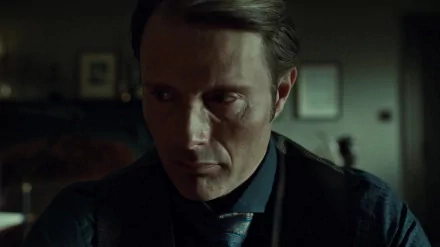 HD desktop wallpaper featuring a dark, intense close-up of a character from the TV show Hannibal, highlighting moody lighting and dramatic expression.
