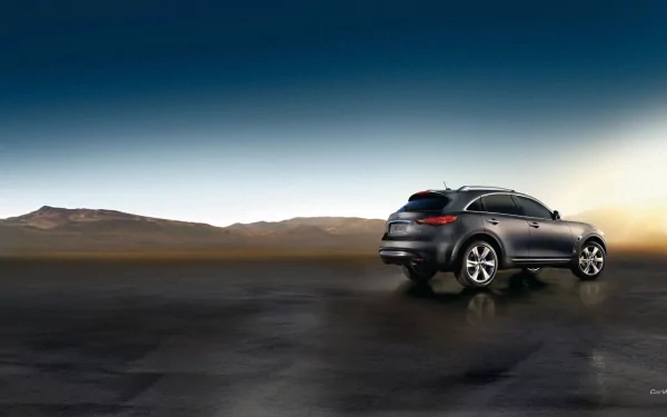 HD desktop wallpaper featuring an Infiniti QX70 SUV driving on a reflective, wet surface with mountains and a clear sky in the background.