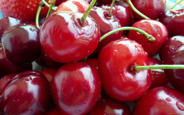 HD desktop wallpaper featuring a close-up of fresh, shiny red cherries clustered together as vibrant food imagery.