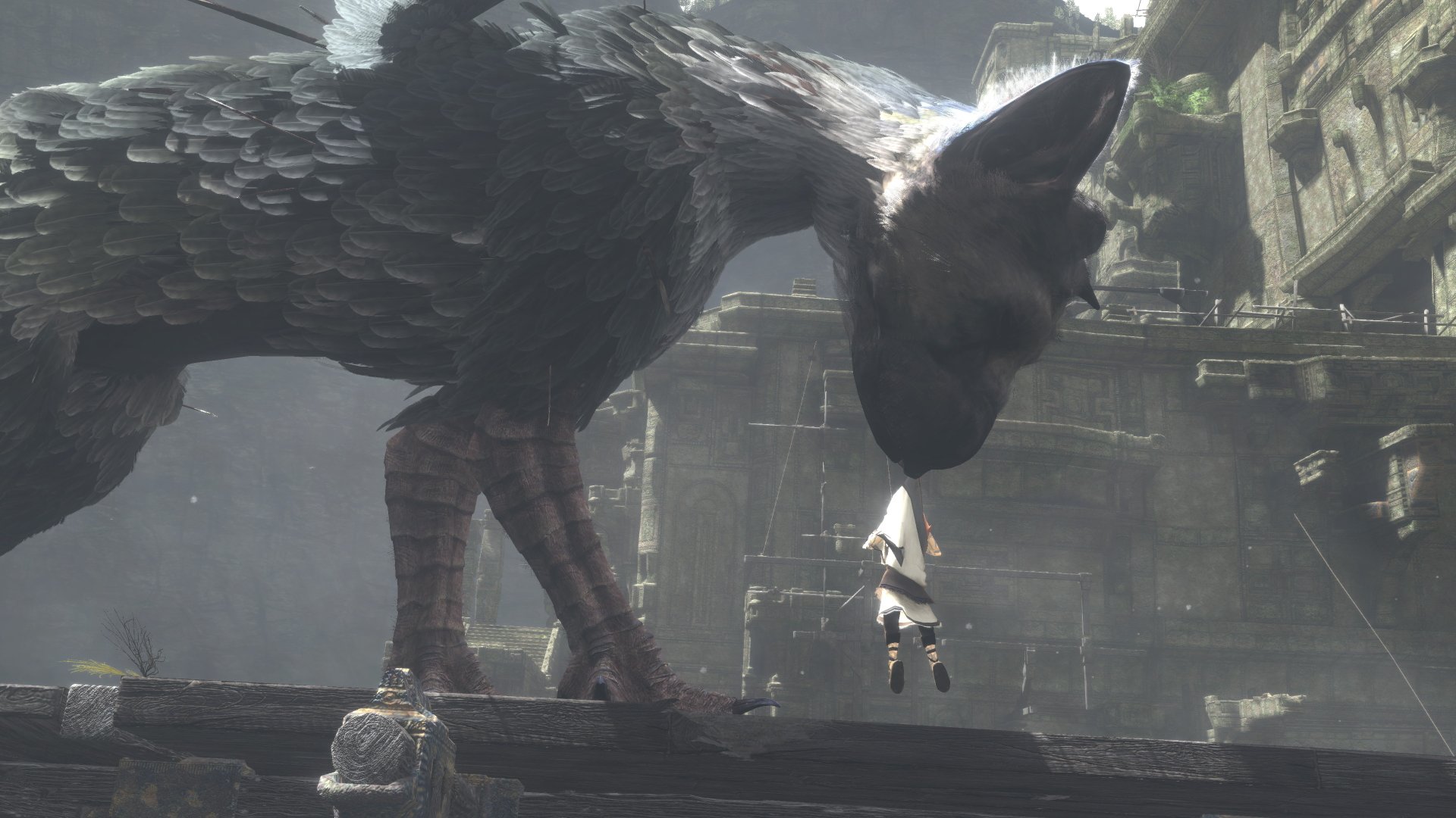 A stunning HD wallpaper from the video game The Last Guardian, featuring a large creature gently interacting with a small character against a mysterious, ancient backdrop.