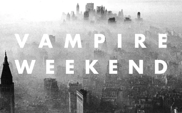 Monochrome foggy aerial cityscape overlaid with bold white VAMPIRE WEEKEND text — HD PC desktop wallpaper/background referencing the music of Vampire Weekend.