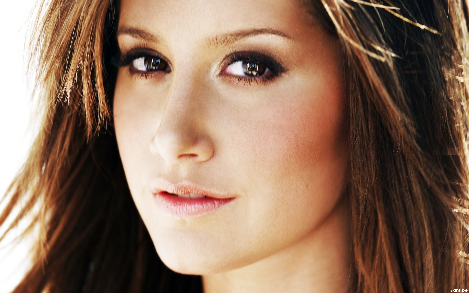 HD PC desktop wallpaper featuring a close-up portrait of celebrity Ashley Tisdale with soft lighting and natural makeup.