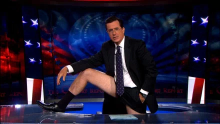 HD wallpaper of Stephen Colbert on the set of The Colbert Report with a patriotic backdrop.
