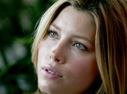 HD desktop wallpaper featuring a close-up portrait of celebrity Jessica Biel with soft lighting and a blurred background.