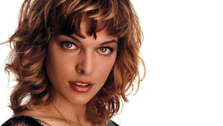 HD desktop wallpaper featuring a close-up portrait of celebrity Milla Jovovich with tousled hair against a white background.
