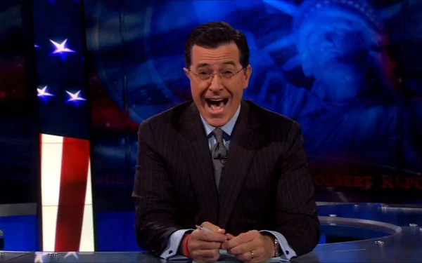 HD wallpaper featuring Stephen Colbert on the set of The Colbert Report, with American flag motifs in the background.