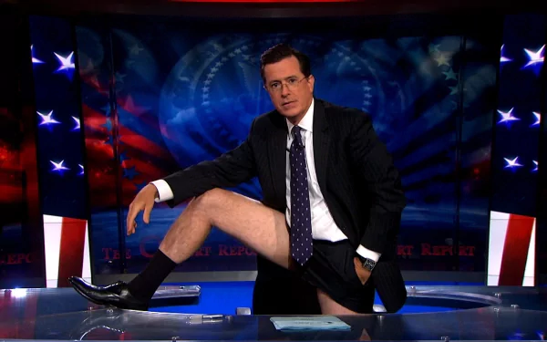 HD wallpaper of Stephen Colbert on the set of The Colbert Report with a patriotic backdrop.