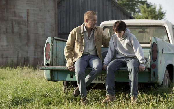 HD PC desktop wallpaper: Jonathan Kent and young Clark Kent sit on a pickup truck tailgate in a grassy yard, sharing a quiet, reflective moment from the movie Man of Steel.