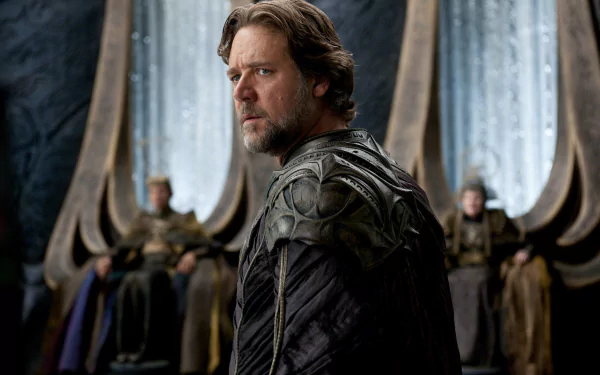 HD PC desktop wallpaper featuring a scene from the movie Man of Steel, showing a focused man in dark armor with blurred figures seated in the background.