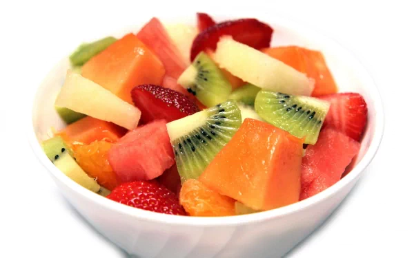 HD PC desktop wallpaper featuring a vibrant bowl of mixed fresh fruit, including kiwi, strawberries, watermelon, and citrus slices.