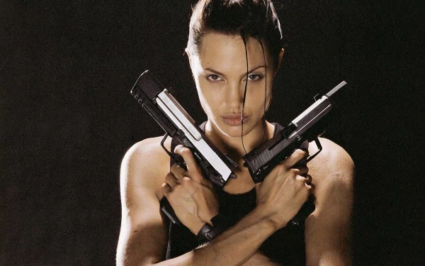 2K Quad HD PC desktop wallpaper of Lara Croft (Tomb Raider): intense, close-up portrait of the tomb raider holding two pistols crossed over her chest against a dark background.