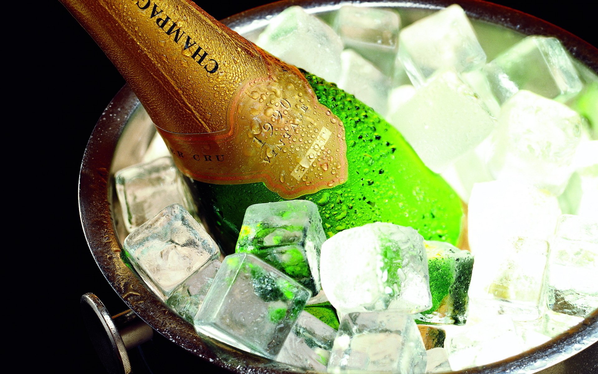 HD desktop wallpaper showing a chilled champagne bottle nestled in a bucket filled with ice cubes, highlighting food and champagne themes.