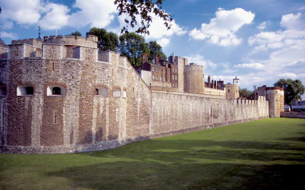 HD PC desktop wallpaper featuring a majestic man-made castle with stone walls under a blue sky dotted with clouds.