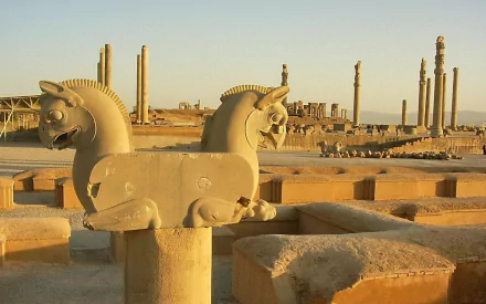 HD PC desktop wallpaper showcasing the man-made ancient ruins of Persepolis with detailed stone carvings and towering columns under a clear sky.
