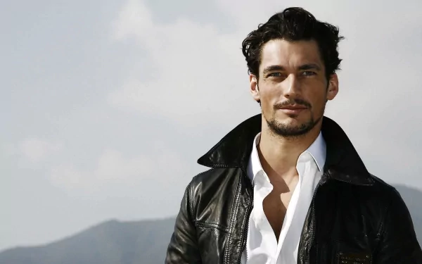 HD PC desktop wallpaper featuring a confident man with dark hair wearing a black leather jacket over a white shirt, set against a blurred outdoor background.