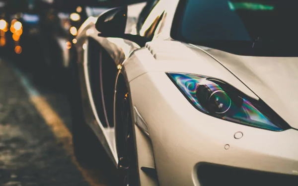 HD wallpaper featuring a close-up of a white McLaren MP4-12C against a blurred city lights background.