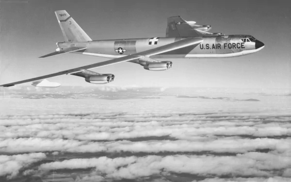 A Boeing B-52 Stratofortress from the U.S. Air Force soars above a cloud blanket, captured in striking detail for a military-themed 4K Ultra HD desktop wallpaper.