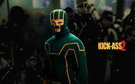 Kick-Ass in a green-and-yellow suit stands before a shadowy crowd with the Kick-Ass 2 logo to the right — HD PC desktop wallpaper from the Kick-Ass movie.