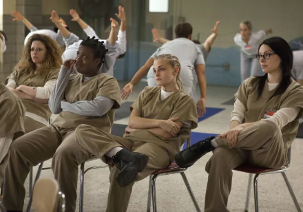 HD desktop wallpaper featuring characters from Orange Is the New Black sitting together, in a prison setting.