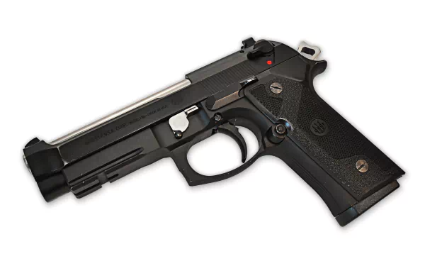 4K Ultra HD image of a Beretta handgun isolated on white, showcasing its detailed black metal and textured grip design.