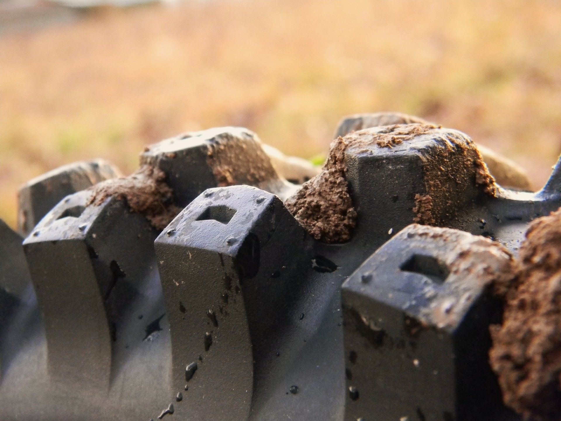 Close-up of a motocross tire showing mud and dirt, highlighting the rugged details essential for off-road sports. This 4K Ultra HD image serves as a dynamic desktop wallpaper.