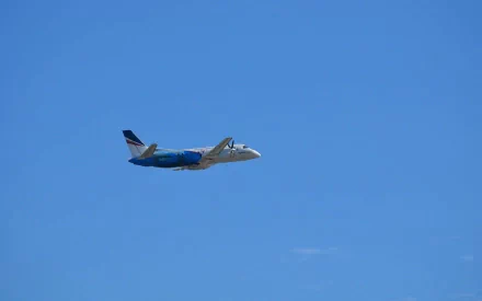 HD desktop wallpaper featuring a Saab 340B aircraft flying against a clear blue sky, showcasing the Saab 340 airplane vehicle in flight.