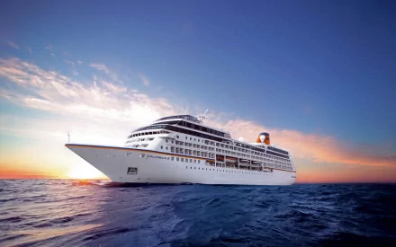 HD PC desktop wallpaper/background of the cruise ship Ms Columbus 2, a white multi‑deck passenger vessel gliding across a calm ocean at sunset beneath a colorful sky.