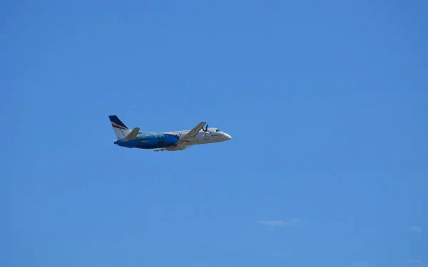 HD desktop wallpaper featuring a Saab 340B aircraft flying against a clear blue sky, showcasing the Saab 340 airplane vehicle in flight.