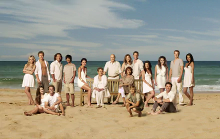 HD PC desktop wallpaper featuring the full cast of the TV show Home and Away posing together on a sunny beach with a calm ocean backdrop.