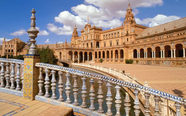A stunning HD wallpaper depicting the architectural beauty of Plaza de España, showcasing intricate details of the balustrade and grand buildings under a vibrant sky.