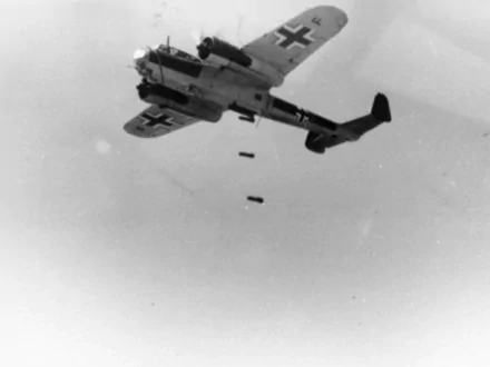 Black-and-white HD PC desktop wallpaper showing a military Dornier Do 17 bomber releasing bombs against a pale sky.