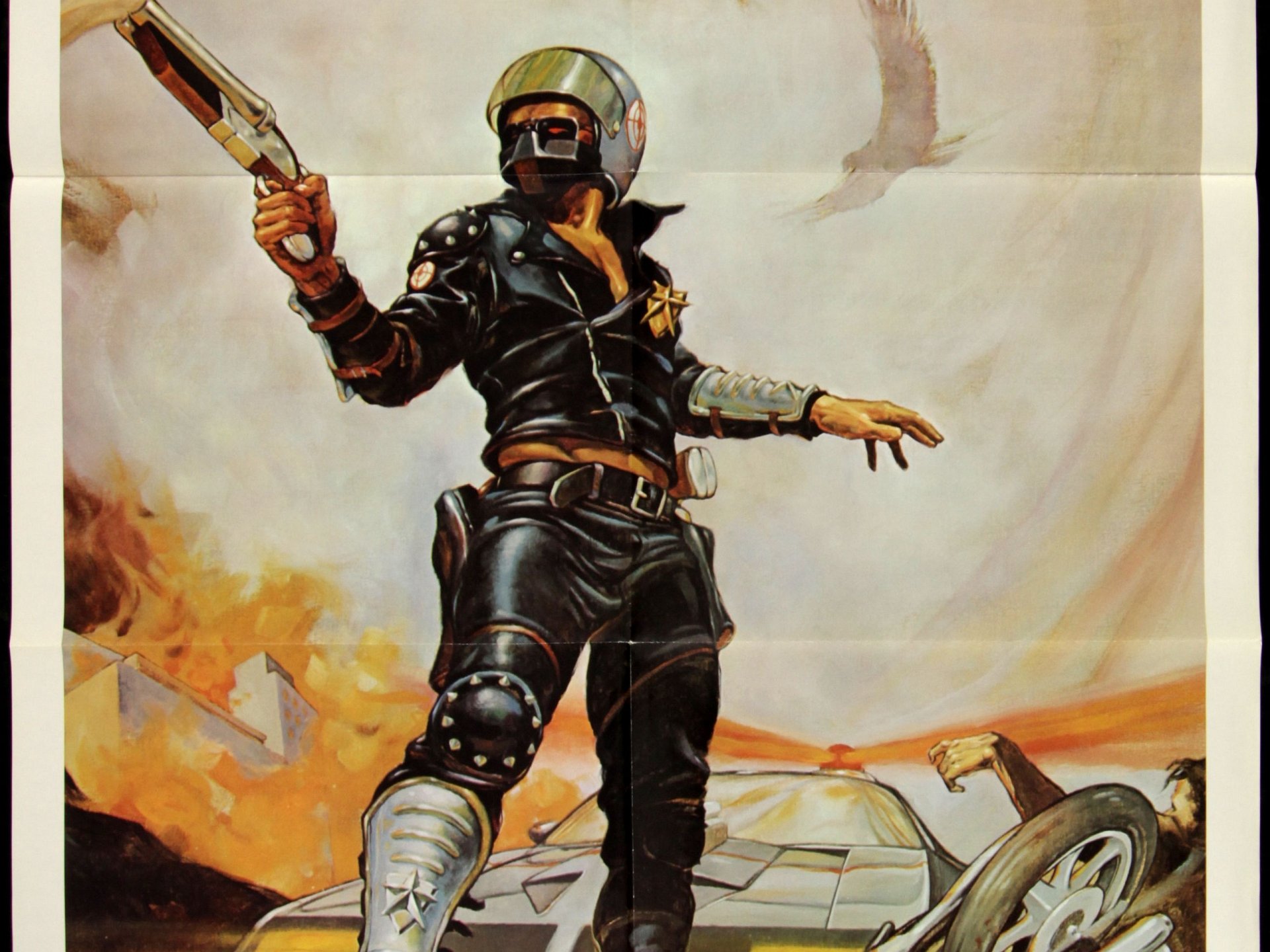 HD PC desktop wallpaper featuring an action-packed scene from the movie Mad Max, showcasing the iconic character in a dynamic pose with a fiery background.