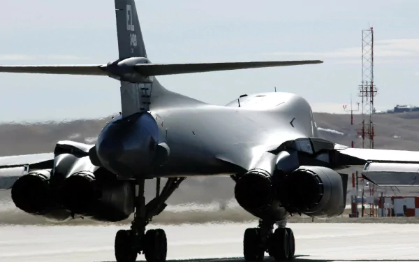 HD PC desktop wallpaper featuring the rear view of a Rockwell B-1 Lancer military bomber on a runway.