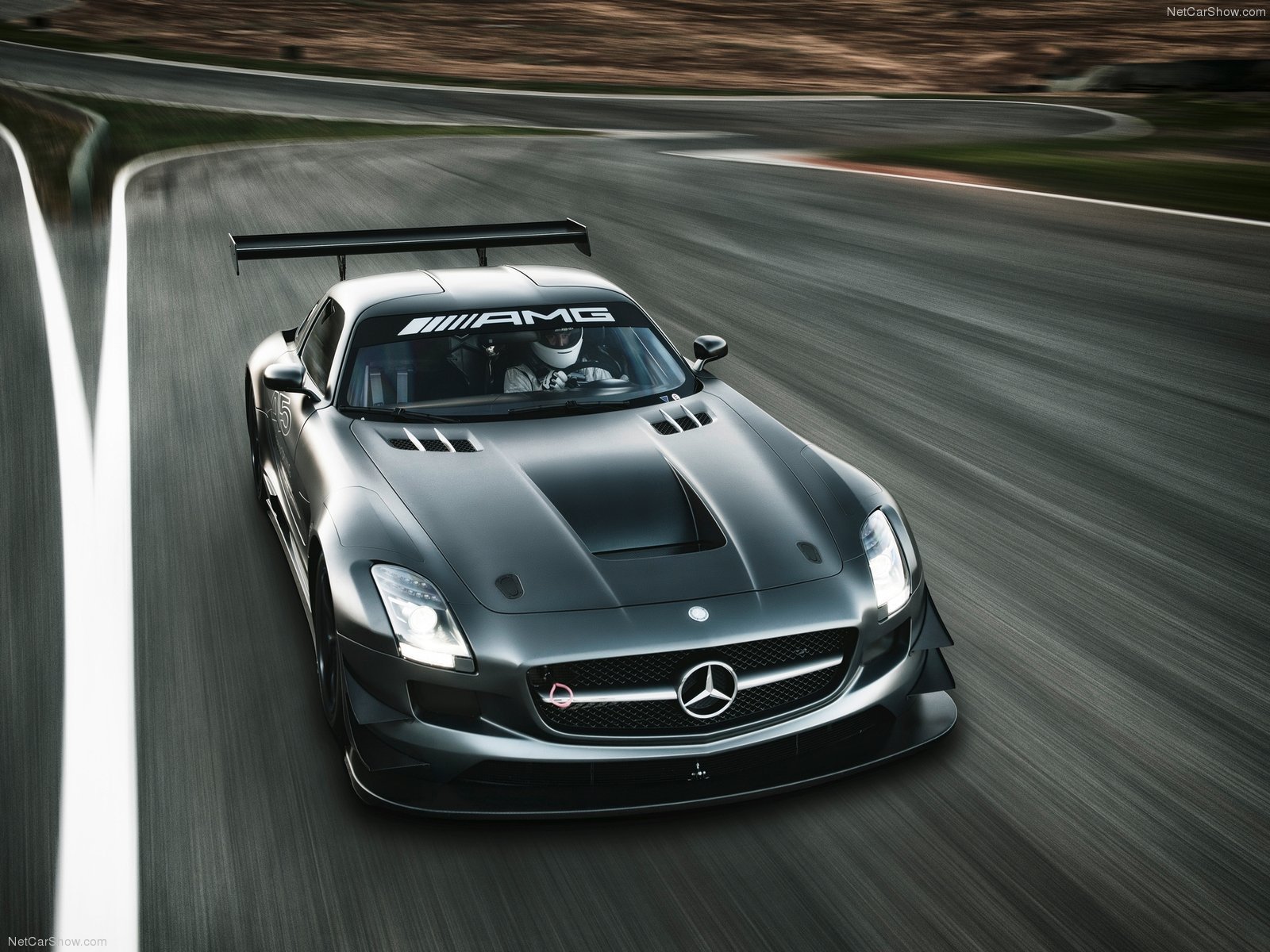HD PC desktop wallpaper featuring a sleek black Mercedes-Benz AMG racing car speeding on a track.