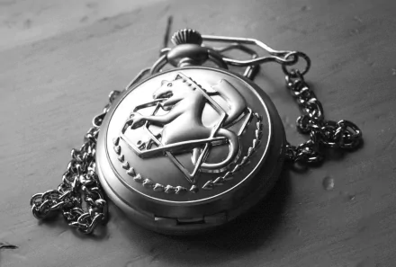 Black and white HD desktop wallpaper featuring a close-up of a pocket watch from Fullmetal Alchemist, showcasing the iconic Flamel symbol.