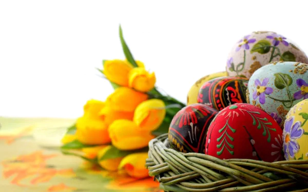 A vibrant 8K Ultra HD Easter-themed wallpaper featuring a basket of intricately decorated eggs beside bright yellow tulips on a soft background.