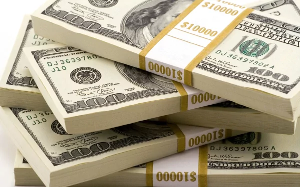 A close-up view of stacked bundles of cash featuring crisp hundred-dollar bills, set against a clean background, making for a striking HD desktop wallpaper.