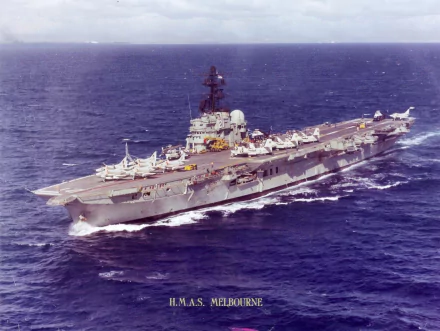 HD desktop wallpaper featuring the military aircraft carrier HMAS Melbourne (R21) sailing through calm ocean waters.